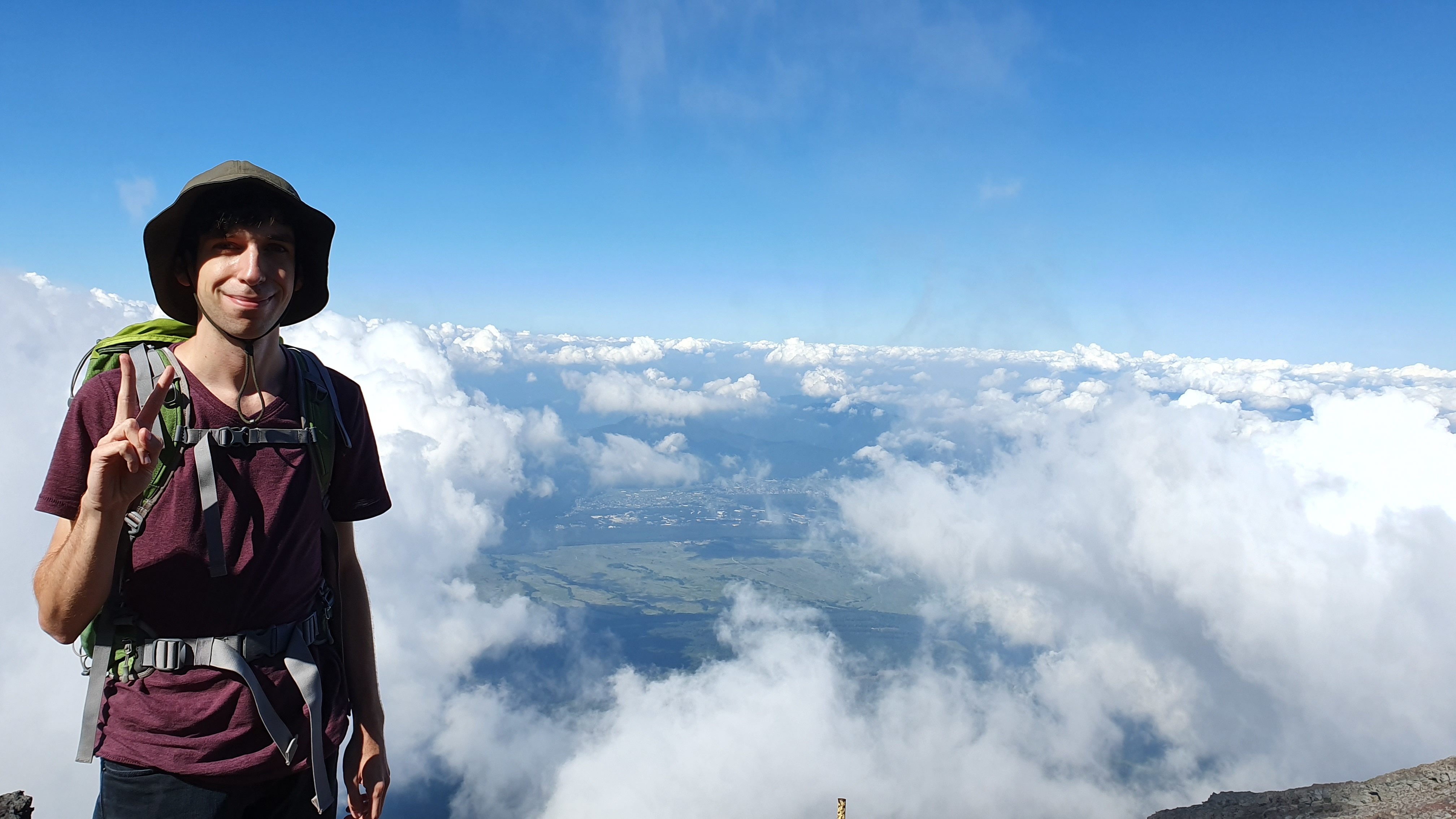 Hiker above clouds on Mt Fuji