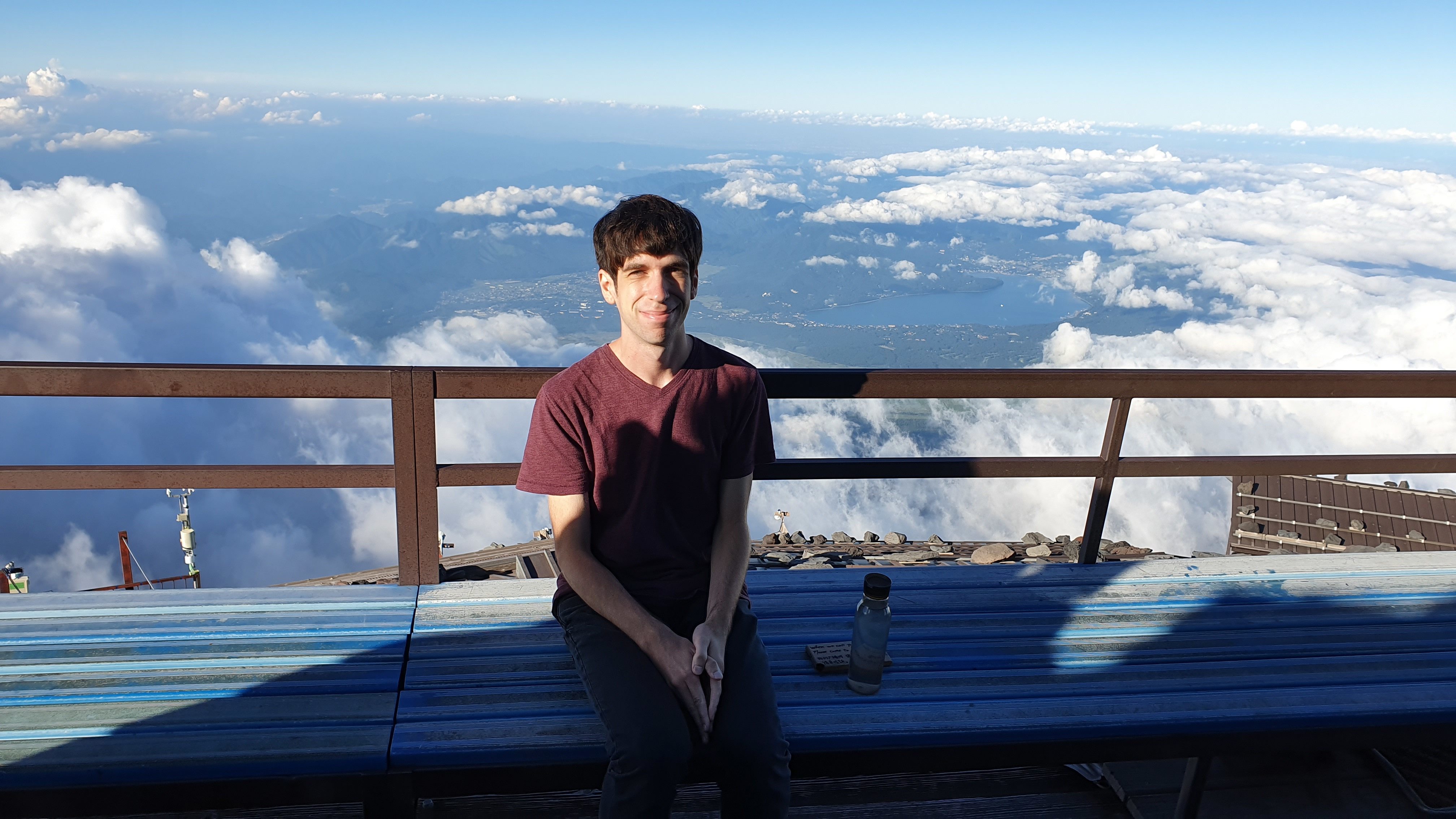 Man sitting above clouds on Mt Fuji