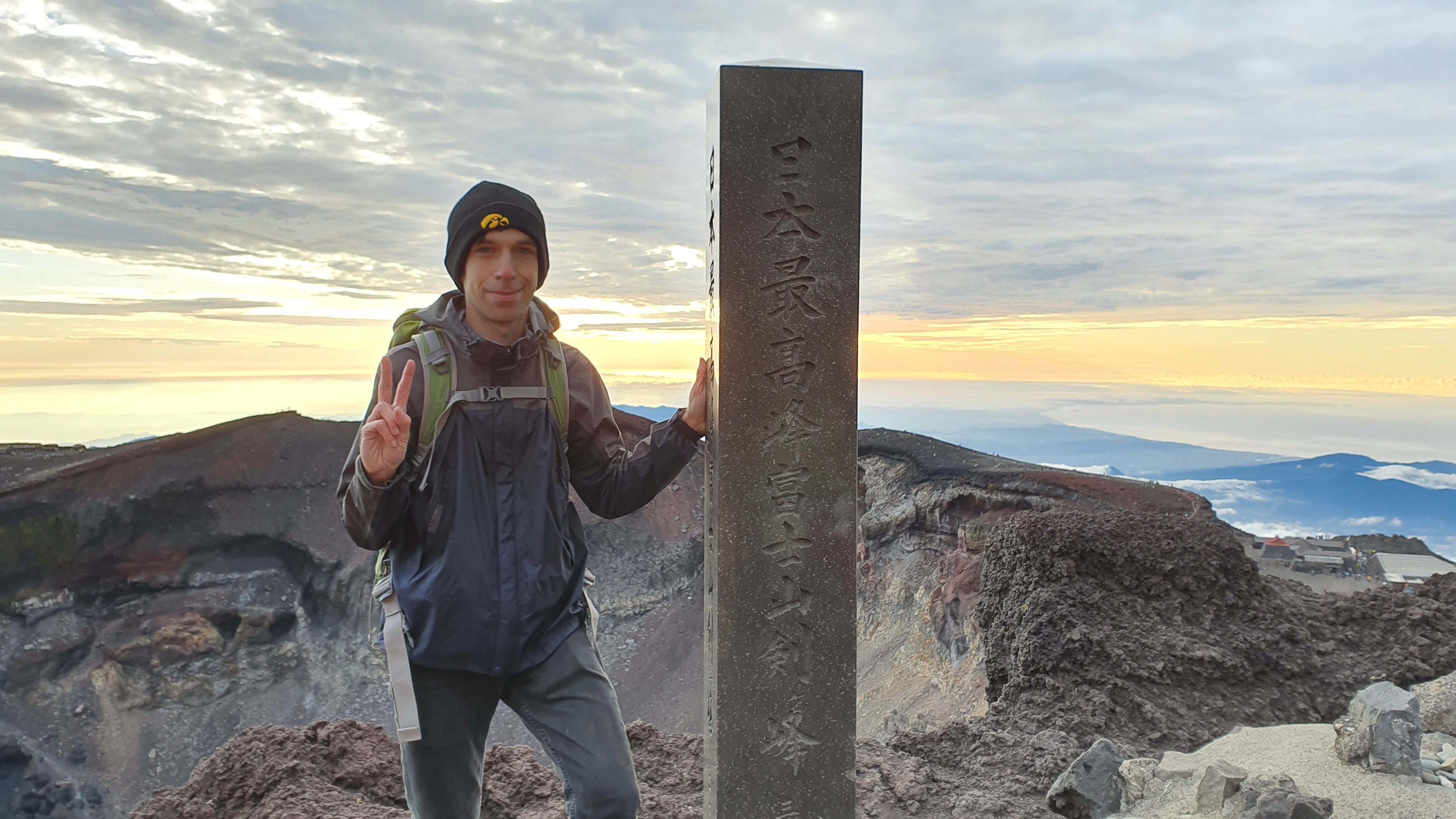 Hiker at summit of Mt Fuji at sunrise