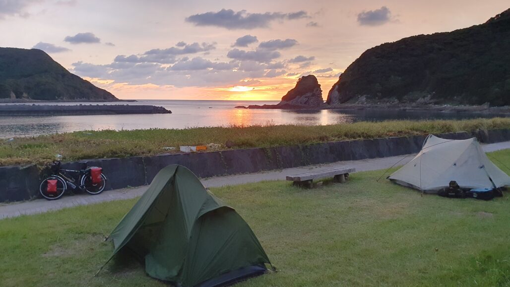 A campsite with two tents set up at Cape Sata.